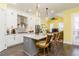 Bright kitchen features white cabinets, gray island, stainless steel appliances, and modern pendant lighting at 963 South On Main Dr, Woodstock, GA 30188