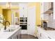 Kitchen with stainless appliances, white cabinetry and adjacent doorway to living room at 963 South On Main Dr, Woodstock, GA 30188