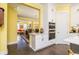 Bright kitchen with stainless appliances, white cabinetry and doorway to living room at 963 South On Main Dr, Woodstock, GA 30188
