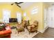 Bright, cheerful living room with yellow walls, multiple windows, and comfortable seating at 963 South On Main Dr, Woodstock, GA 30188