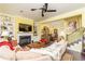 Open-concept living room with hardwood floors, fireplace, and views into the dining area at 963 South On Main Dr, Woodstock, GA 30188