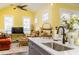 Cozy living room with bright yellow walls and ceiling fan adjacent to kitchen at 963 South On Main Dr, Woodstock, GA 30188
