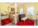 Bedroom suite with luxury 4-poster bed, plenty of natural light, and hardwood floors at 963 South On Main Dr, Woodstock, GA 30188