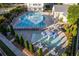 Community pool and splash pad with lounge seating, umbrellas, and landscaping at 963 South On Main Dr, Woodstock, GA 30188