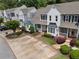 A beautiful row of townhomes featuring well-manicured lawns and private parking at 1002 Saddle Hl, Marietta, GA 30068