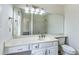 Bathroom featuring a large mirror, dual vanity, white cabinets, and view to shower and toilet at 1002 Saddle Hl, Marietta, GA 30068