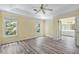 Bedroom with wood-look floors, ceiling fan, tray ceiling, windows, and ensuite bathroom at 1002 Saddle Hl, Marietta, GA 30068