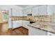Kitchen featuring granite countertops, tile backsplash and white cabinets at 1002 Saddle Hl, Marietta, GA 30068