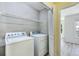 Laundry room with washer, dryer and overhead shelving at 1002 Saddle Hl, Marietta, GA 30068
