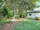 Serene backyard featuring lush greenery, mature trees, and a well-maintained lawn, perfect for outdoor relaxation and entertaining at 1356 Emory Ne Rd, Atlanta, GA 30306