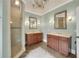 Spacious bathroom with double vanities, tiled floors, and a glass enclosed shower at 1356 Emory Ne Rd, Atlanta, GA 30306