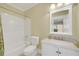Bathroom featuring tile floors, a marble vanity, toilet, tub, and neutral color palette at 1356 Emory Ne Rd, Atlanta, GA 30306