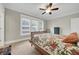 Bedroom features a ceiling fan, closet, large windows, bed, and neutral color palette at 1356 Emory Ne Rd, Atlanta, GA 30306