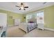 Bedroom features a ceiling fan, closet, large windows, bed, and neutral color palette at 1356 Emory Ne Rd, Atlanta, GA 30306