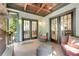 Comfortable covered porch with chairs and view inside through the French doors at 1356 Emory Ne Rd, Atlanta, GA 30306