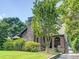 Charming brick home with stone chimney, lush landscaping, and covered arched entryway offering curb appeal at 1356 Emory Ne Rd, Atlanta, GA 30306