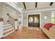 Inviting foyer featuring hardwood floors, staircase, dark wood doors, and ample natural light at 1356 Emory Ne Rd, Atlanta, GA 30306