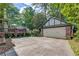 Detached two-car garage with brick accents, spacious driveway, and lush landscaping in the backyard at 1356 Emory Ne Rd, Atlanta, GA 30306