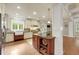 Bright eat-in kitchen features an island, stainless steel appliances, granite countertops, and hardwood floors at 1356 Emory Ne Rd, Atlanta, GA 30306
