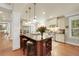 Bright eat-in kitchen features an island with seating, stainless steel appliances, and hardwood floors at 1356 Emory Ne Rd, Atlanta, GA 30306