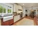 Well-lit kitchen with stainless steel appliances, custom cabinets, a farm sink, and hardwood floors at 1356 Emory Ne Rd, Atlanta, GA 30306