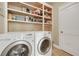 Laundry room features a washer, dryer, tiled floor, and built in shelving at 1356 Emory Ne Rd, Atlanta, GA 30306