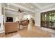 Open floor plan with hardwood floors and exposed beams leads into the eat-in kitchen at 1356 Emory Ne Rd, Atlanta, GA 30306