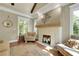Cozy living room with white brick fireplace, hardwood floors, and neutral decor at 1356 Emory Ne Rd, Atlanta, GA 30306