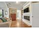 Comfortable living room with a fireplace, hardwood floors, and a large television at 1356 Emory Ne Rd, Atlanta, GA 30306