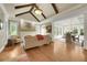 Bright living room featuring hardwood floors, coffered ceilings, a fireplace, and an open dining area at 1356 Emory Ne Rd, Atlanta, GA 30306