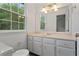 Bathroom with large window, vanity with marble top, and a toilet at 2025 Oakley Se Trce, Smyrna, GA 30080