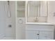 Bright bathroom featuring subway tile shower, vanity with white cabinets and a large mirror at 2025 Oakley Se Trce, Smyrna, GA 30080