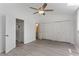Spacious bedroom with ceiling fan, ample closet space, and hardwood flooring at 2025 Oakley Se Trce, Smyrna, GA 30080