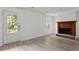 Open-concept living room with a brick fireplace and access to the front door at 2025 Oakley Se Trce, Smyrna, GA 30080