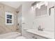 Nicely tiled bathroom with shower-tub combination and updated fixtures at 2584 Oldknow Dr, Atlanta, GA 30318
