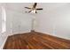 Unfurnished bedroom shows hardwood floors, ceiling fan and two white doors at 2584 Oldknow Dr, Atlanta, GA 30318