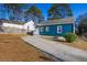 Exterior view of a charming blue single-story home with a long driveway at 2584 Oldknow Dr, Atlanta, GA 30318
