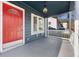 Inviting front porch features a vibrant red door, bay window and classic white railing at 2584 Oldknow Dr, Atlanta, GA 30318