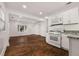 The bright and open kitchen features white cabinets, granite countertops, and modern appliances at 2584 Oldknow Dr, Atlanta, GA 30318