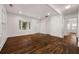 Open-concept living room with beautiful hardwood floors, bright white walls, and bay window at 2584 Oldknow Dr, Atlanta, GA 30318
