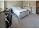 Neutral bedroom has a distressed wood bed frame with carpet and a dresser with a mirror at 360 Hayden Cir, Woodstock, GA 30189