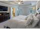 Bright primary bedroom featuring tray ceilings, carpet, and en suite bathroom at 360 Hayden Cir, Woodstock, GA 30189