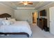 Spacious bedroom with large bed and tray ceilings, carpet, next to a doorway at 360 Hayden Cir, Woodstock, GA 30189