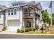 Two-story townhome showcases a balcony, an attached garage, and manicured landscaping at 360 Hayden Cir, Woodstock, GA 30189