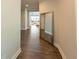 Hallway features wood floors, neutral paint, and a mirror, creating an inviting space at 360 Hayden Cir, Woodstock, GA 30189