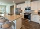 Kitchen features stainless steel appliances, granite countertops, and seating for three at 360 Hayden Cir, Woodstock, GA 30189