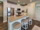 Eat-in kitchen features granite countertops, stainless steel appliances, and modern stools at 360 Hayden Cir, Woodstock, GA 30189