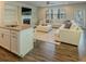 Open living room with fireplace, built-in shelves, and kitchen island seating at 360 Hayden Cir, Woodstock, GA 30189