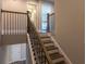 Stairway with a dark stained handrail and balusters leads to the upper level of the home at 360 Hayden Cir, Woodstock, GA 30189