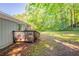 Home's deck leads to backyard with green trees at 4650 Big Valley Ct, Stone Mountain, GA 30083